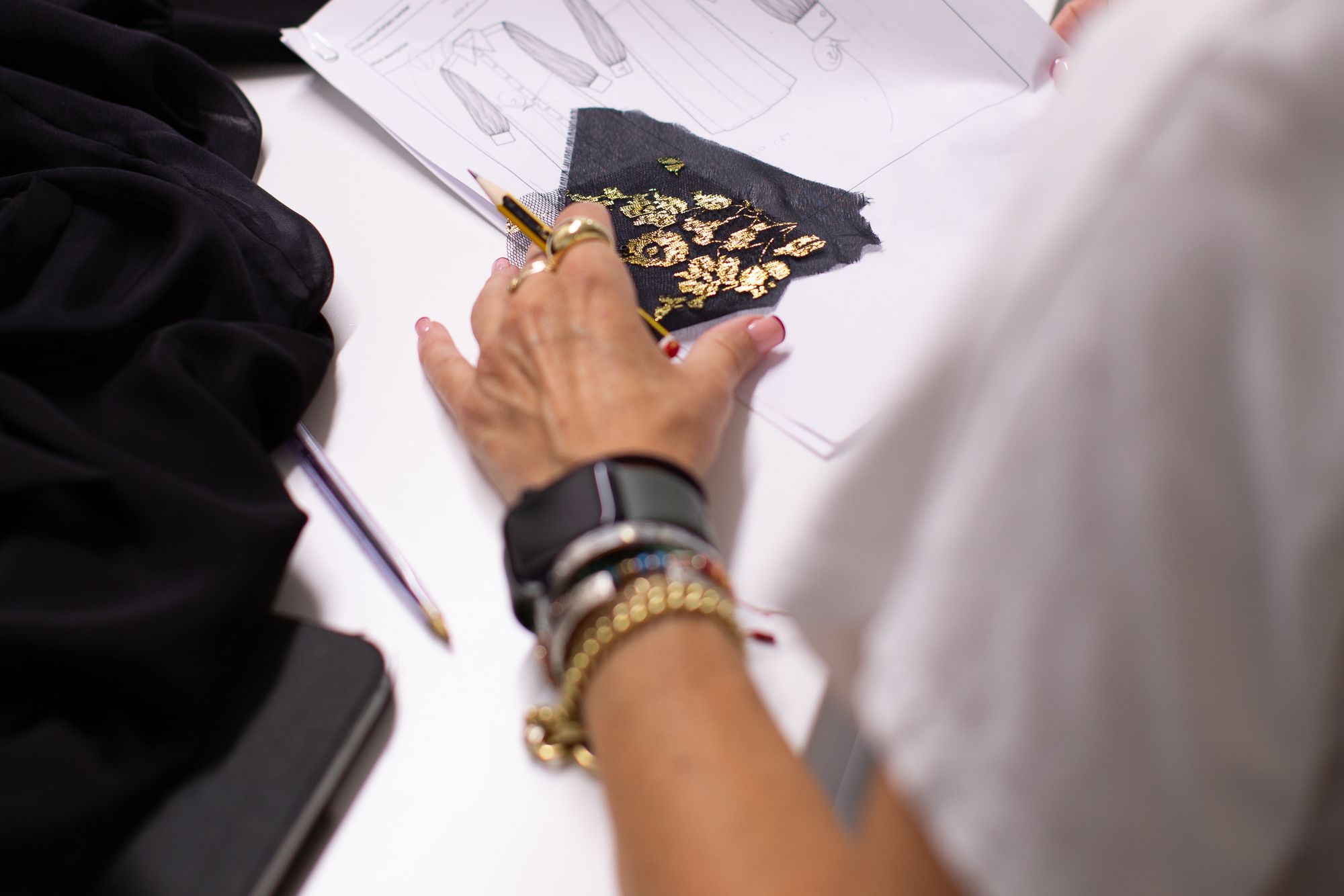 Pattern cutter working at the table with card and pencil
